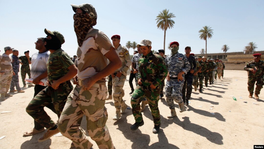 Shi'ite volunteers, who have joined the Iraqi army to fight against militants of the Islamic State, formerly known as the Islamic State in Iraq and the Levant (ISIL), march during training in Baghdad, July 9, 2014. 