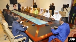 Burkina Faso President Blaire Compaore (R), the top mediator in Mali's crisis, and his delegation meet at the presidential palace in Ouagadougou with rebel leaders (R) from the Islamist Ansar Dine, one of the groups controlling the country's north, June 1