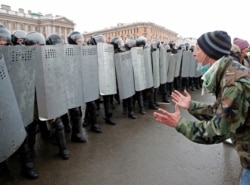 A demonstrator shouts in front of law enforcement officers during a rally in support of jailed Russian opposition leader Alexey Navalny in Saint Petersburg, Russia on Jan. 31, 2021. REUTERS/Anton Vaganov