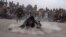Dua pria Afghanistan adu gulat di hadapan para penonton,di taman Chaman-e-Huzori, Kabul, Afghanistan, Jumat, 3 Desember 2021. Adu gulat tradisional yang menarik perhatian banyak orang ini, digelar setiap minggu, selepas salat Jumat.