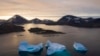 FILE - Large icebergs float away as the sun rises near Kulusuk, Greenland, on Aug. 16, 2019. 