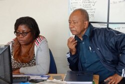 Capital Radio Director Alaudin Osman (right) cross checks news bulletin content with editor Wezi Nyirongo before it goes on air.