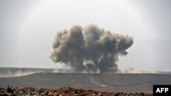 FILE - Smoke billows during clashes between forces loyal to Yemen's Saudi-backed government and Houthi rebel fighters in Yemen's northeastern province of Marib, March 5, 2021. 