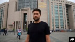 Andrew Gardner, seorang peneliti pada Amnesty International di Turki, berpose di luar gedung pengadilan di Istanbul (17/7), di mana 6 aktivis HAM akan diadili di sana. 