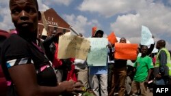 FILE - Workers are seen holding placards during a labor protest in Harare, Zimbabwe.