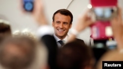 FILE - French President Emmanuel Macron arrives for the annual May Day ceremony at the Elysee Palace, in Paris, France, May 1, 2019. 