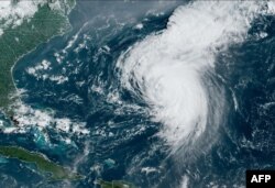 This satellite image obtained from the National Oceanic and Atmospheric Administration shows Hurricane Ernesto at 12:50 Zulu on August 16, 2024.