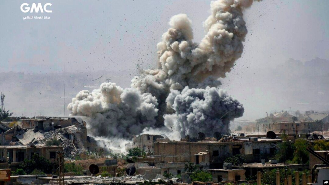 This photo provided Monday, Sept 25, 2017, by the Ghouta Media Center, a Syrian activist media group, shows smoke and debris rising after Syrian government shelling of the rebel-held Jobar neighborhood of Damascus, Syria.