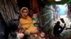 FILE - Rohingya refugees are seen outside their makeshift tent in the Kutupalong camp, Cox's Bazar, Bangladesh, Aug. 24, 2018. 