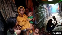 FILE - Rohingya refugees are seen outside their makeshift tent in the Kutupalong camp, Cox's Bazar, Bangladesh, Aug. 24, 2018. 