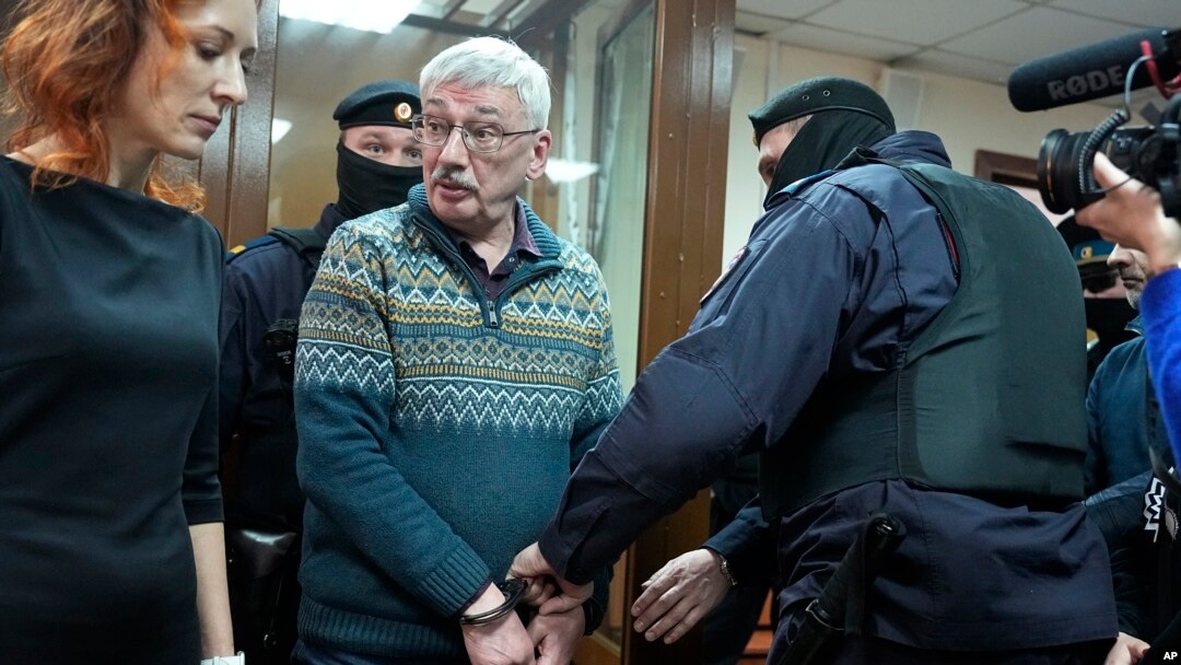 The co-chair of the Nobel Peace Prize-winning Memorial human rights group, Oleg Orlov, is taken into custody in the courtroom during a session for a new trial on charges of repeatedly discrediting the Russian military, in Moscow, Russia, on Feb. 27, 2024. 