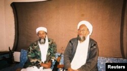FILE PHOTO: Osama bin Laden with advisor Ayman al-Zawahiri during interview