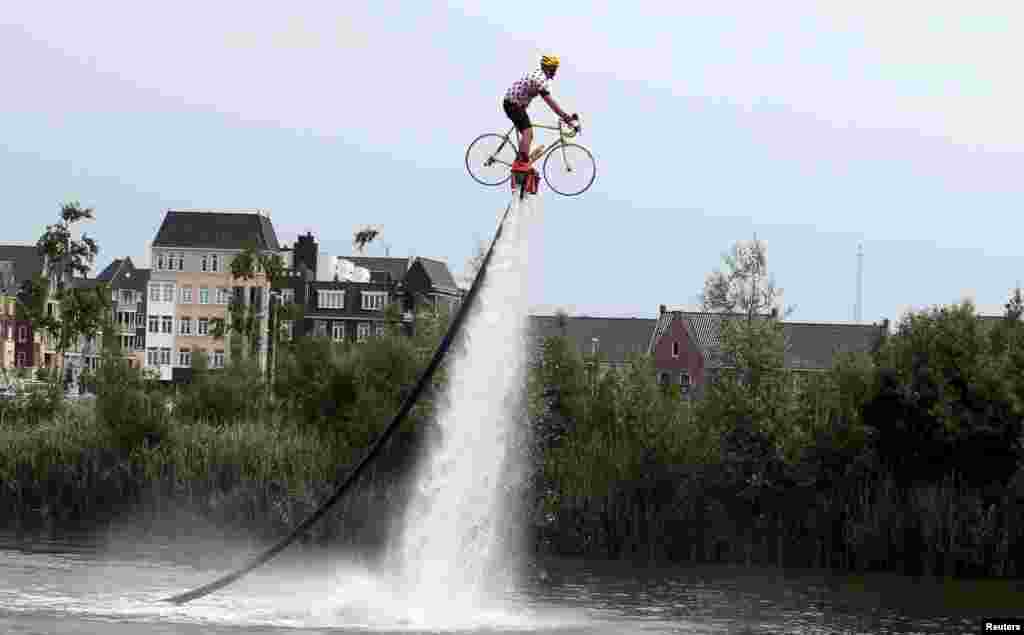 A man wearing a Tour de France best climber&#39;s jersey practices flyboarding before the start of the 166-km (103.15 miles) second stage of the 102nd Tour de France cycling race from Utrecht to Zeeland, the Netherlands.