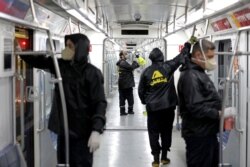 Workers disinfect subway trains against coronavirus in Tehran, Iran, in the early morning of Feb. 26, 2020.