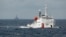 FILE - A Chinese Coast Guard vessel, with the disputed oil rig in the background, is seen in the South China Sea, June 2014.