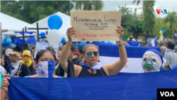 Una mujer sostiene una pancarta en una protesta en Managua contra el gobierno de Daniel Ortega. Foto Houston Castillo, VOA.