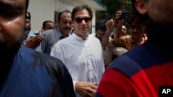 Pakistani politician Imran Khan, chief of Pakistan Tehreek-e-Insaf party, arrives to cast his vote at a polling station for the parliamentary elections in Islamabad, Pakistan, July 25, 2018.