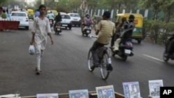 Pirated CDs and DVDs of Bollywood films are displayed for sale at a roadside stall in Ahmadabad, India, 18 Mar 2010