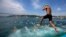 A competitor jump into the water to swim from Asia to Europe during the annual Bosphorus Cross-Continental swimming competition in Istanbul July 7, 2013. 