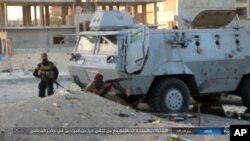 FILE - This photo posted on a file sharing website Jan. 11, 2017, by the Islamic State Group in Sinai shows a deadly attack by militants on an Egyptian police checkpoint, Jan. 9, 2017, in el-Arish, north Sinai, Egypt.