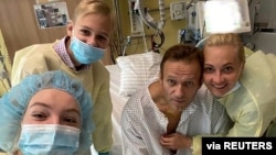 FILE - Russian opposition politician Alexei Navalny and his family members pose for a picture at Charite hospital in Berlin, Germany, in this undated image obtained from social media, Sept. 15, 2020. (Courtesy of Instagram @NAVALNY/Social Media)