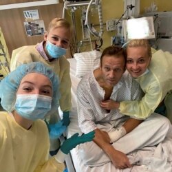 FILE - Russian opposition politician Alexei Navalny and his family members pose for a picture at Charite hospital in Berlin, Germany, in this undated image obtained from social media, Sept. 15, 2020. (Instagram @Navalny)