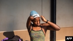 Uganda’s Husnah Kukundakwe, 16, prepares to get ready for a swimming training session at Elite swim and gym center in Kampala on December 19, 2023, ahead of the 2024 Paris Paralympic games.