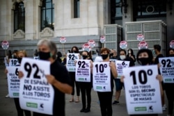 FILE - People hold banners reading in Spanish: "92% of Spain, don't attend the bullfights" during a protest against bullfighting in downtown Madrid, Spain, Sunday, July 12, 2020.