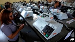 FILE - Electoral Court employees work on the final stage of sealing electronic voting machines in preparation for the general election run-off in Brasilia, Brazil, Oct. 19, 2022, ahead of the Oct. 30 second round vote. 