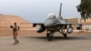 FILE - An Iraqi soldier stands guard near a U.S.-made Iraqi air force F-16 jet at Balad Air Base, north of Baghdad, Iraq, Feb. 13, 2018. 