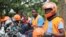 FILE - Motorcycle taxi drivers known as boda bodas, wear SafeBoda safety gear as they wait for customers along a street in Kampala, Uganda, Oct. 5, 2018.
