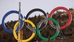 Workers assemble the Olympic rings at the aerials and moguls skiing venue for the Winter Olympics Beijing 2022, in Zhangjiakou, Hebei province, China, November 20, 2021. (Thomas Peter/Reuters)