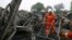 Firefighters clean up the debris after a fire at a rehabilitation center for the elderly in Sanlihe village of Pingdingshan, Henan province, China, May 26, 2015.