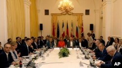 Delegates sit around a table prior to a bilateral meeting as part of the closed-door nuclear talks with Iran at a hotel in Vienna, Austria, July 6, 2018.