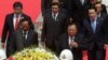 Laos President Bounnhang Vorachith, foreground right, walks together with Cambodian Defense Minister Tea Banh, foreground left, during a ceremony to pay respects at the Monument Independence in Phnom Penh, Cambodia, Wednesday, Feb. 22, 2017. (AP Photo/Heng Sinith)