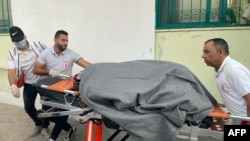 Paramedics transport an injured woman to Kuwaiti hospital in Rafah in the southern Gaza Strip after Israeli bombardment, Oct. 21, 2023