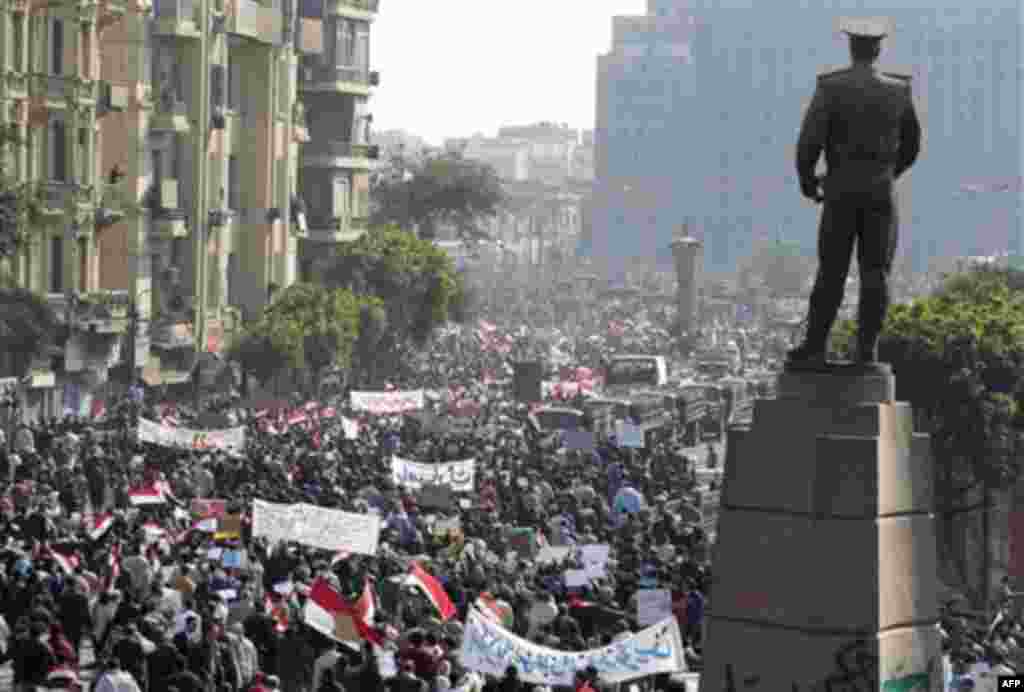 Pro-government supporters demonstrate in Cairo, Egypt, Wednesday, Feb.2, 2011. Several thousand supporters of President Hosni Mubarak, including some riding horses and camels and wielding whips, clashed with anti-government protesters Wednesday as Egypt's