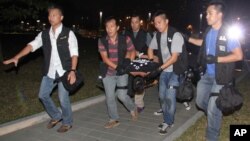 FILE -- Ken Tsang, center, a member of a local pro-democracy political party, is carried by plainclothes police officers after a clash between protesters and police in an occupied area near the government headquarters in Hong Kong, Oct. 15, 2014.