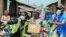 Volunteers gesture as they direct an elderly woman at an ongoing distribution of food parcels, during a lockdown by the authories in efforts to slow the spread of the coronavirus disease (COVID-19), in Lagos, April 9, 2020.