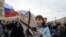 FILE - Opposition activists participate in a rally against Russian President Vladimir Putin, in Saint Petersburg, Russia, May 5, 2018.