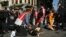Police officers detain protesters after they tried to push through a police barricade blocking access towards Taksim Square in central Istanbul, Turkey, during May Day protests, May 1, 2021.