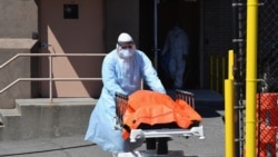 A medical staffer moves the body of a coronavirus victim from the Wyckoff Heights Medical Center to a refrigerated truck, in Brooklyn, New York, April 2, 2020.