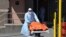 A medical staffer moves the body of a coronavirus victim from the Wyckoff Heights Medical Center to a refrigerated truck, in Brooklyn, New York, April 2, 2020.