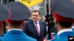 FILE - President of the Bosnian Serb Republic Milorad Dodik inspects an honor guard during a parade in the Bosnian town of Banja Luka, Jan. 9, 2018.