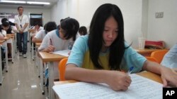 FILE - Junior high students study in a small cram school in hopes of success on their high school entrance exams, in Taipei, Taiwan.