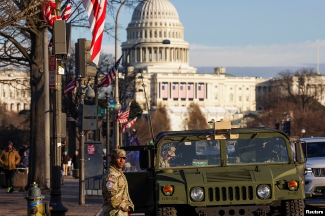 U.S. National Guardsmen patrol on the Pennsylvania Avenue with the Capitol Hill in the background, ahead of the presidential inauguration of President-elect Donald Trump, in Washington, Jan. 18, 2025.