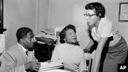 FILE - This file photo shows Autherine Lucy Foster, center, discussing her return to campus following mob demonstrations in Birmingham, Alabama, on Feb. 7, 1956.