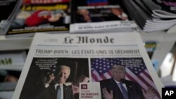 Copies of the French newspaper Le Monde with the headline "Trump-Biden: The United States Is Tearing Itself Apart" is seen at a newspaper stand in Paris, France, Nov. 4, 2020. 