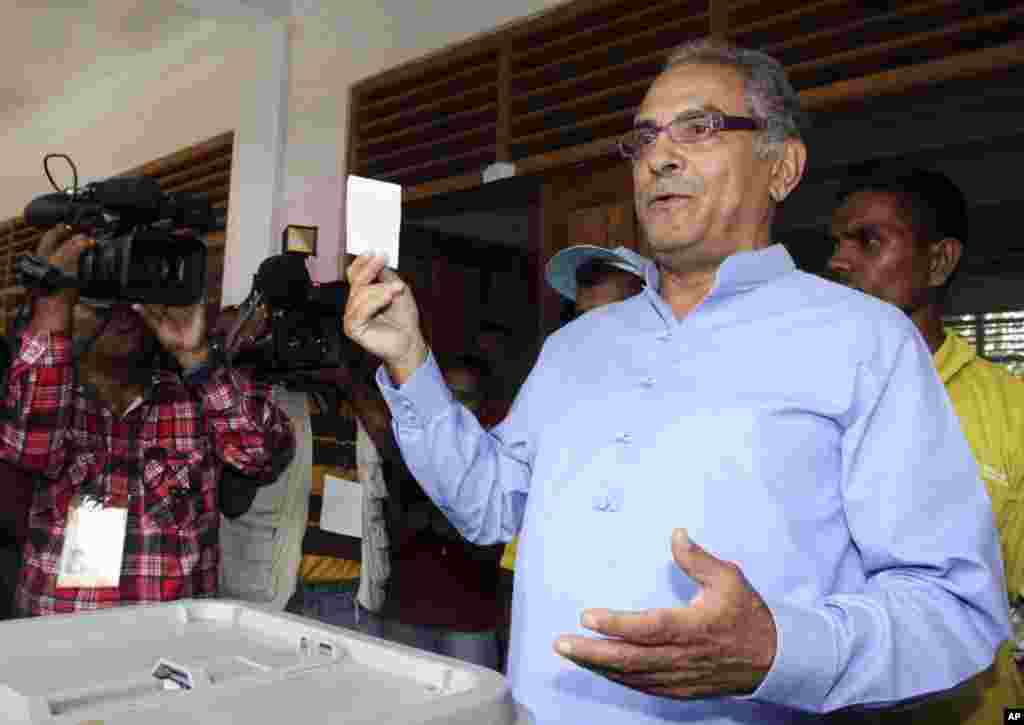 East Timorese President Jose Ramos-Horta shows his ballot before voting in the presidential election in Dili, East Timor, Saturday, March 17, 2012. East Timorese started voting for their new president Saturday, putting to test the young nation's political