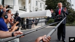 President Donald Trump speaks with reporters on the South Lawn of the White House, Oct. 8, 2018, in Washington. 